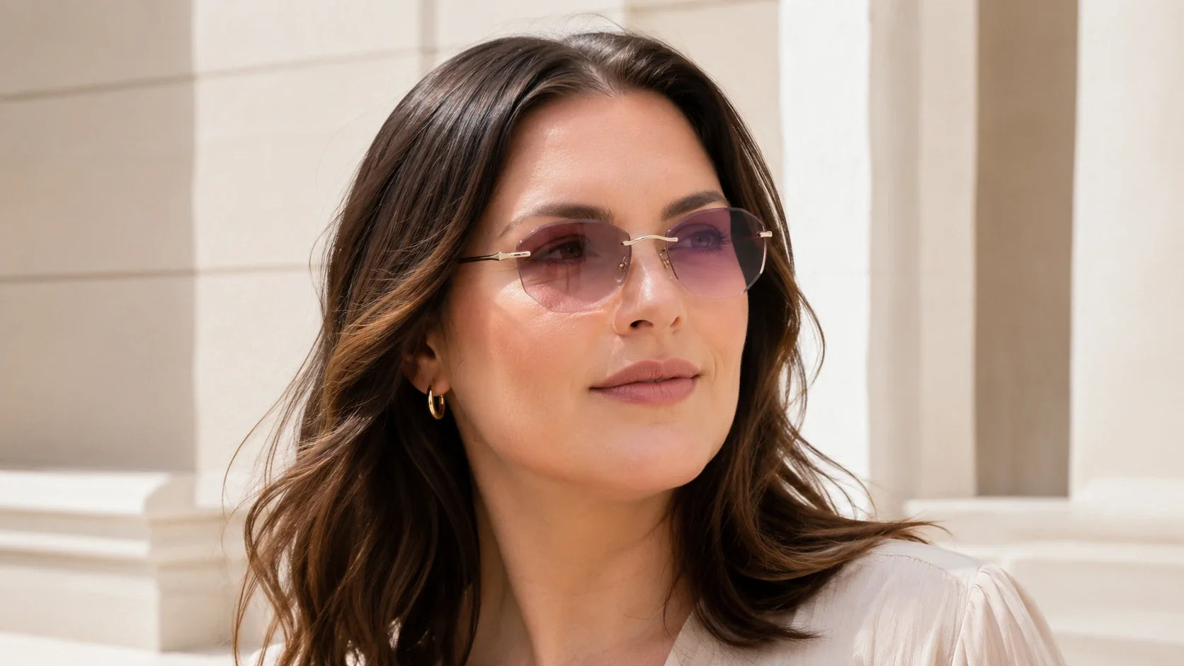 Woman with wide face wearing lightweight rimless sunglasses for an anti-pinch fit