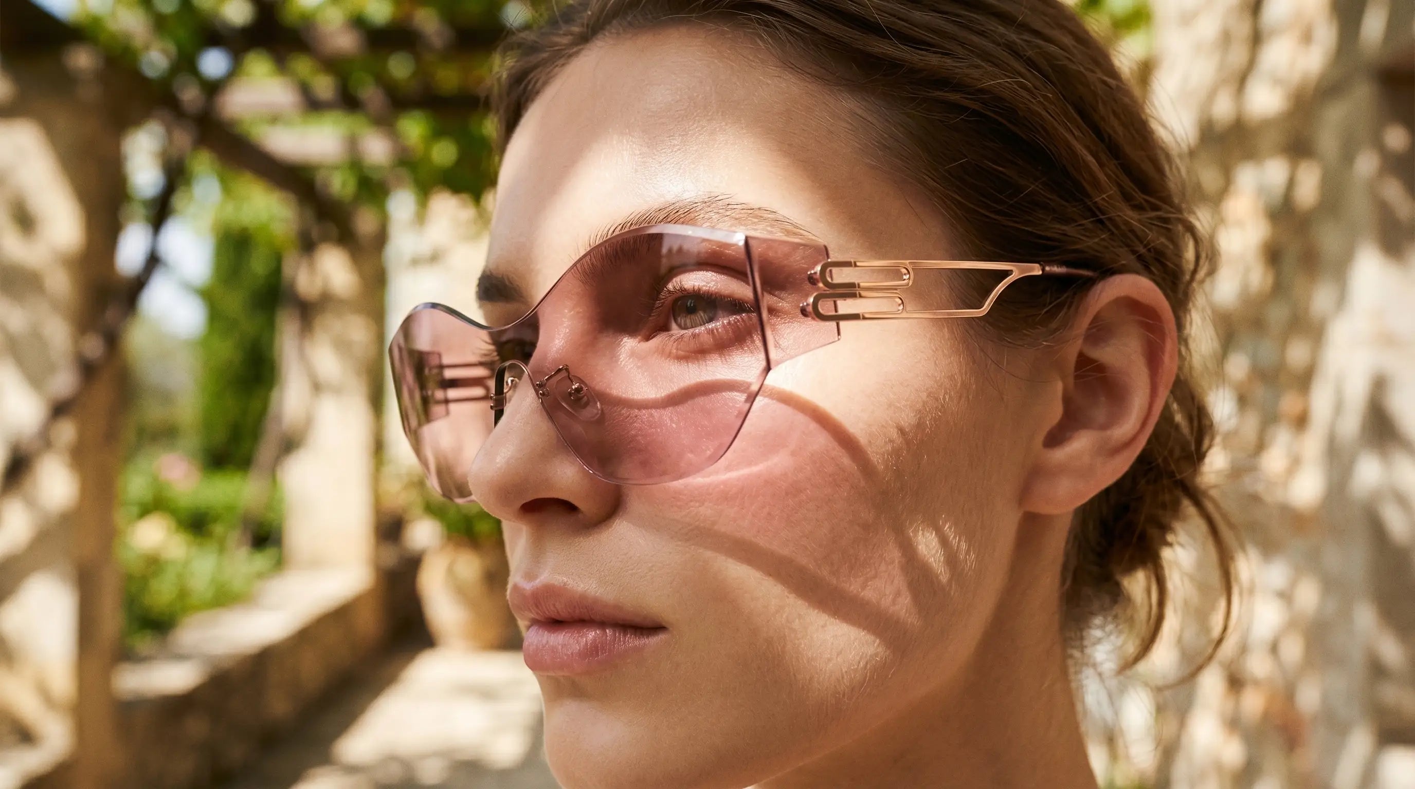 Woman wearing Y2K rimless shield sunglasses with a clean open face look