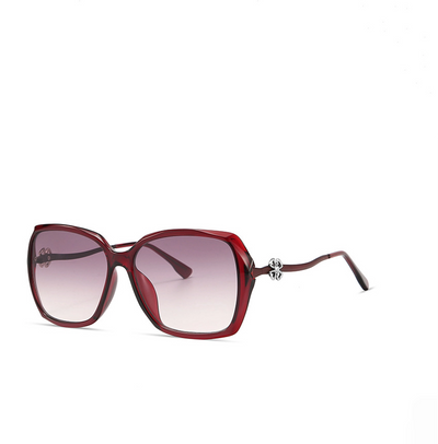 Red sunglasses with a gradient lens on a white background