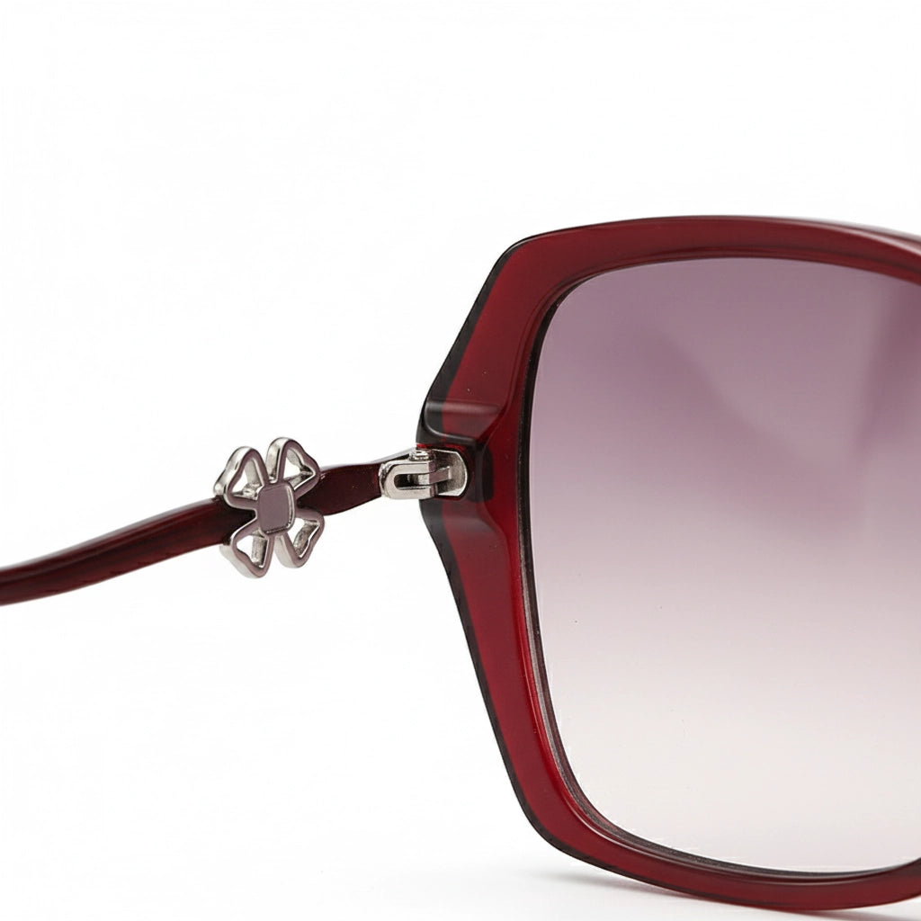 Sunglasses with red frame and gradient lens on a white background