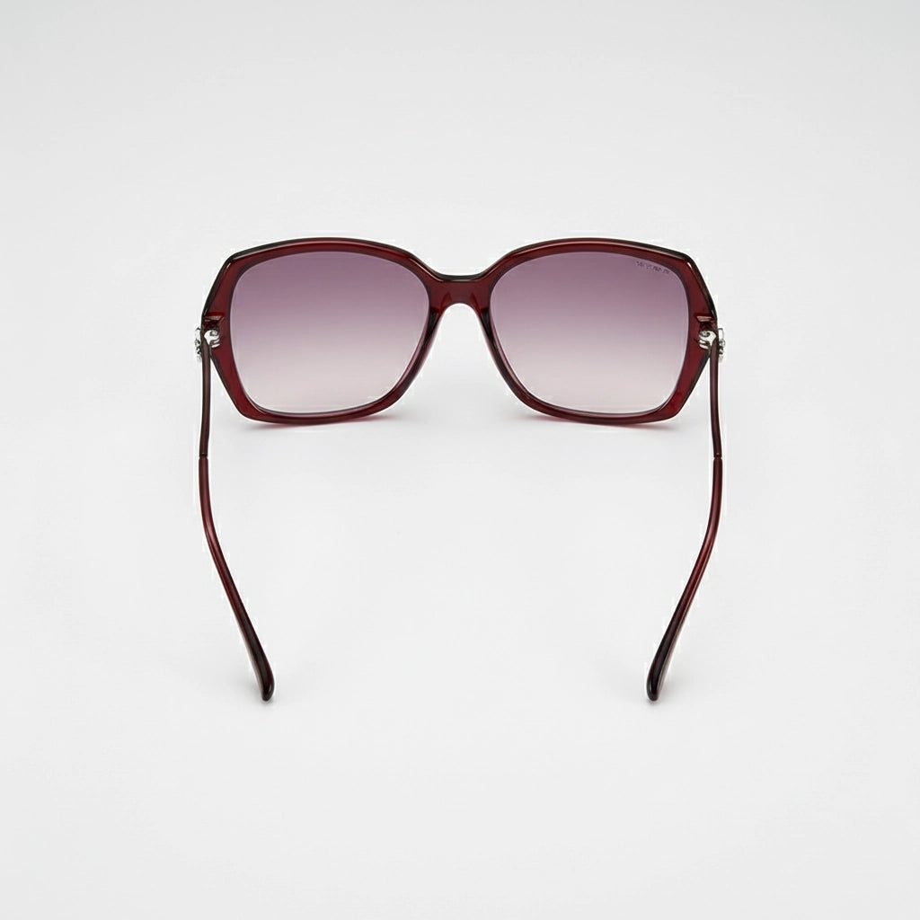 Sunglasses with a maroon frame and gradient lenses on a white background
