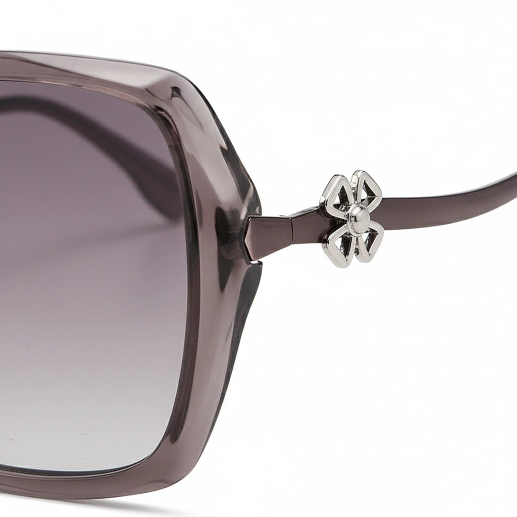 Sunglasses with a decorative bow on the arm against a white background