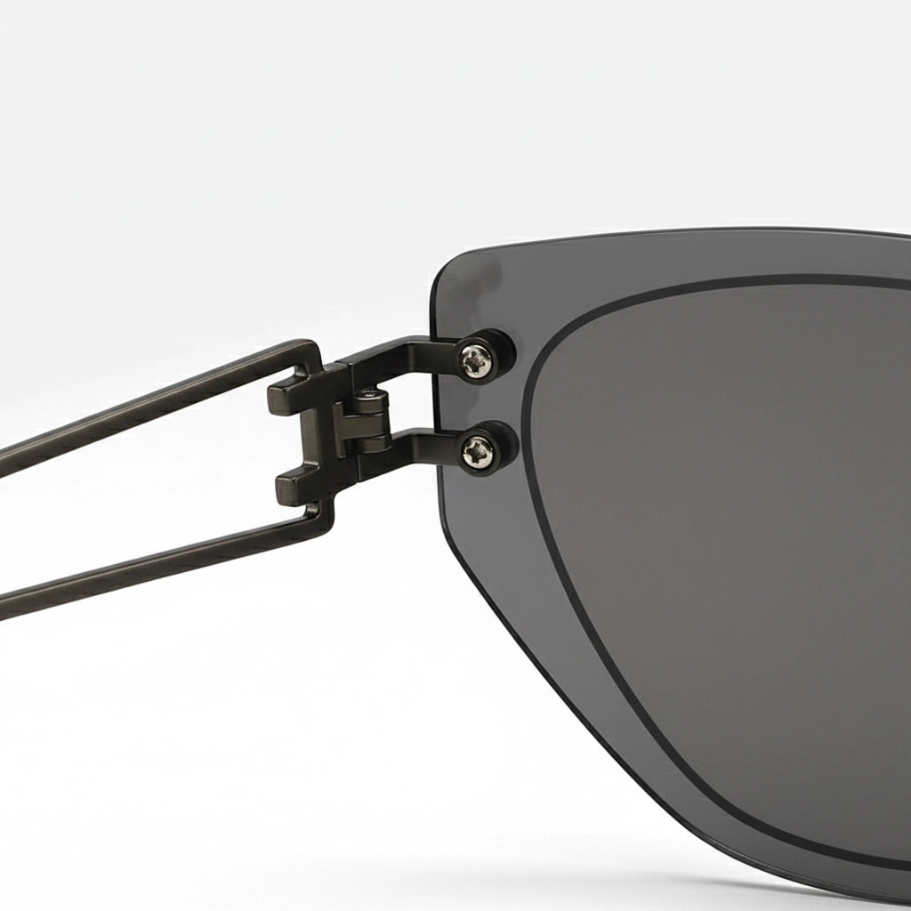 Close-up of a sunglasses with a black frame and gray lenses on a white background
