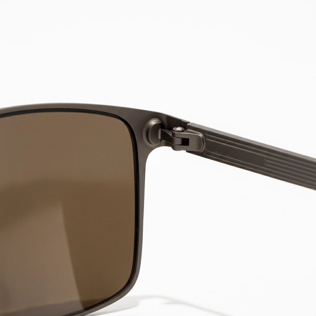 Close-up of a sunglasses with a brown lens on a white background
