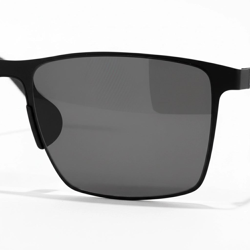 Black sunglasses with dark lenses on a white background