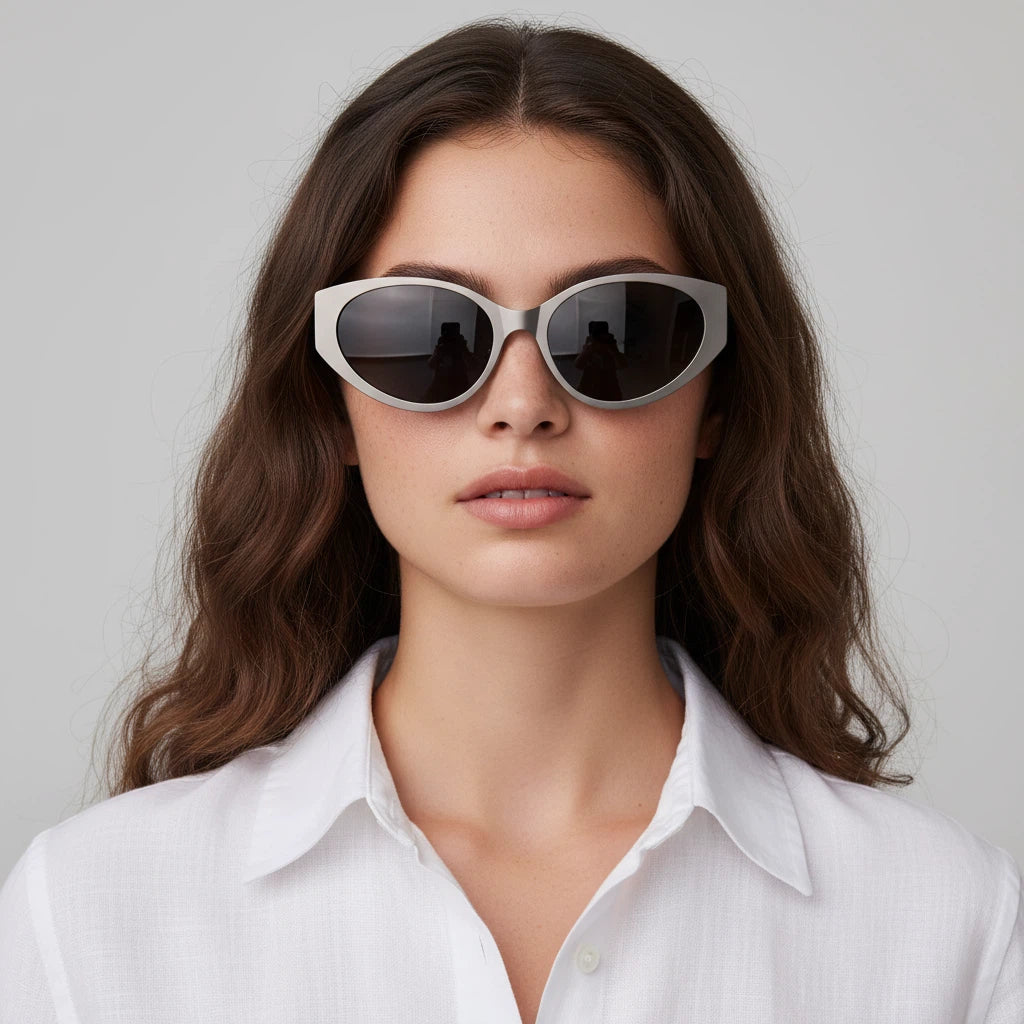 Woman wearing stylish sunglasses with a plain background