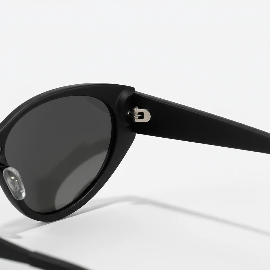 Black sunglasses with a reflective lens on a white background