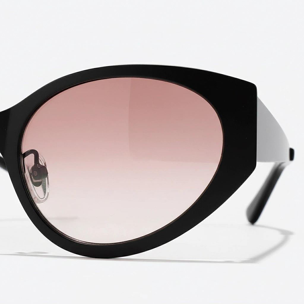 Black sunglasses with pink gradient lenses on a white background