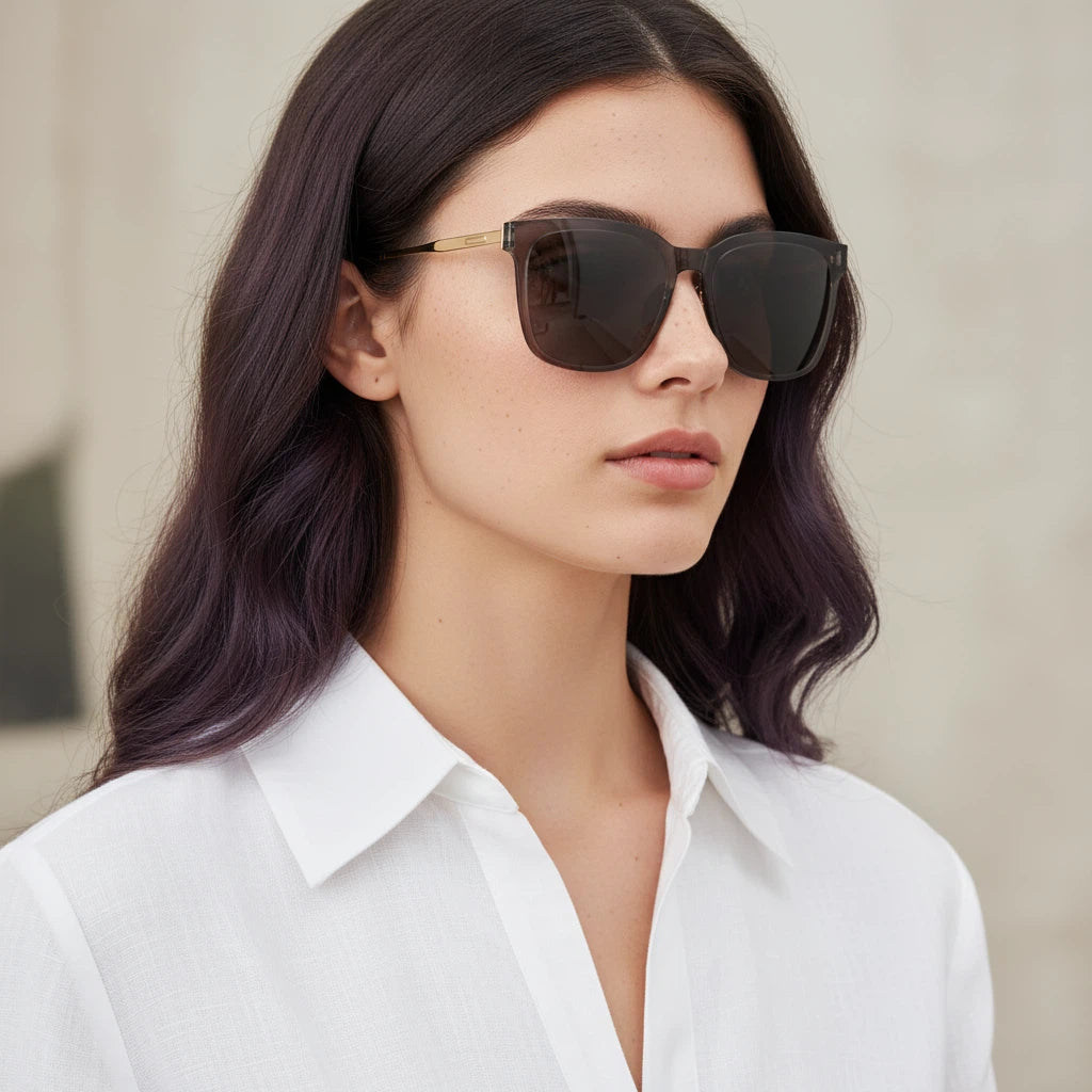 Woman wearing sunglasses with a neutral background