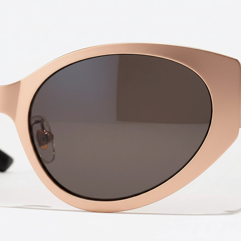 Sunglasses with rose gold frame and dark lenses on a white background