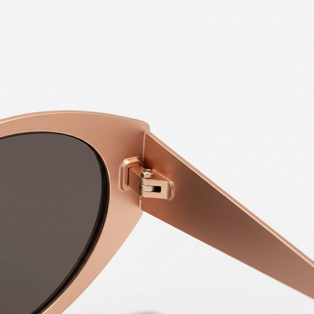 Rose gold sunglasses with a close-up of the frame on a white background