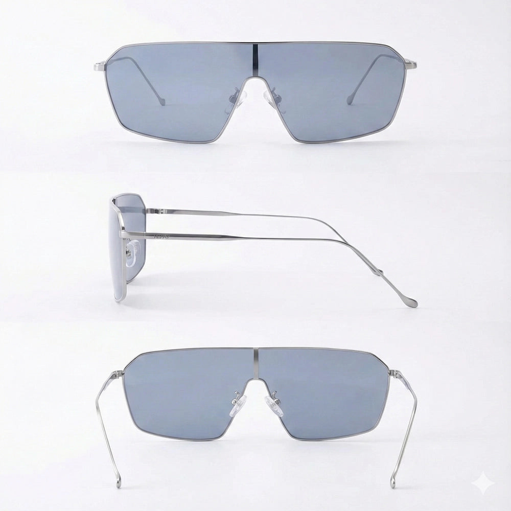 Minimalist oversized flat-top sunglasses with thin silver metal frames and light gray tinted lenses, displayed against a clean white background, showcasing modern, sleek design.
