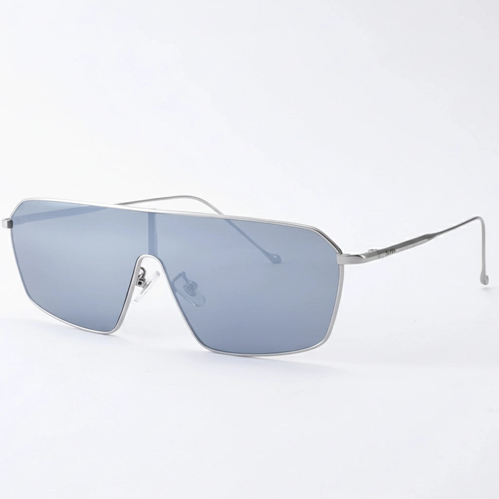 Minimalist oversized flat-top sunglasses with thin silver metal frames and light gray tinted lenses, displayed against a clean white background, showcasing modern, sleek design.