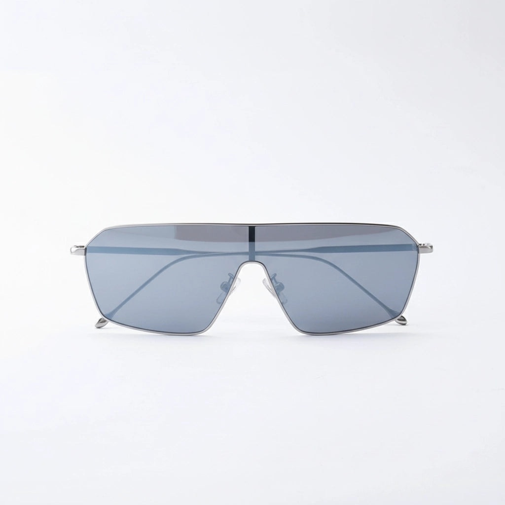 Minimalist oversized flat-top sunglasses with thin silver metal frames and light gray tinted lenses, displayed against a clean white background, showcasing modern, sleek design.