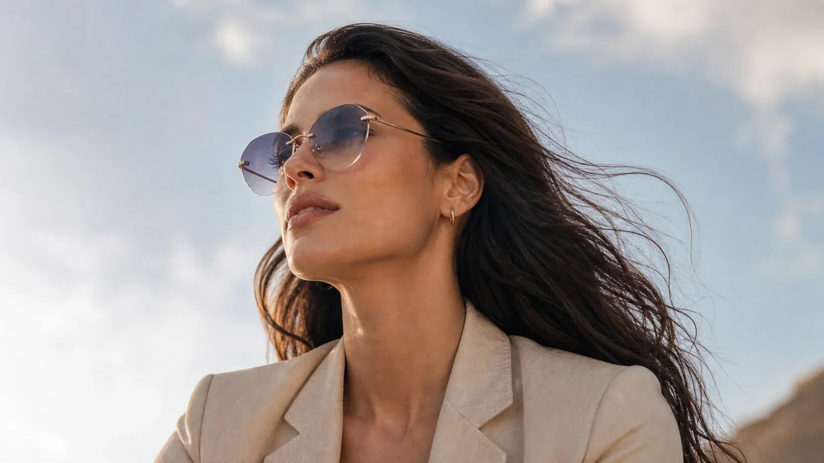 Woman wearing rimless rectangle sunglasses with clean lines for a sharper open face look