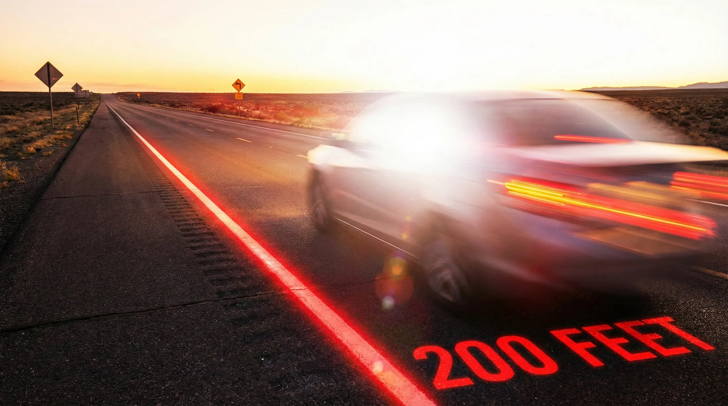 A speeding car (motion-blurred) travels on a desert highway at sunset; "200 FEET" is marked on the road, and traffic signs are visible in the distance, evoking a sense of speed and open-road travel.