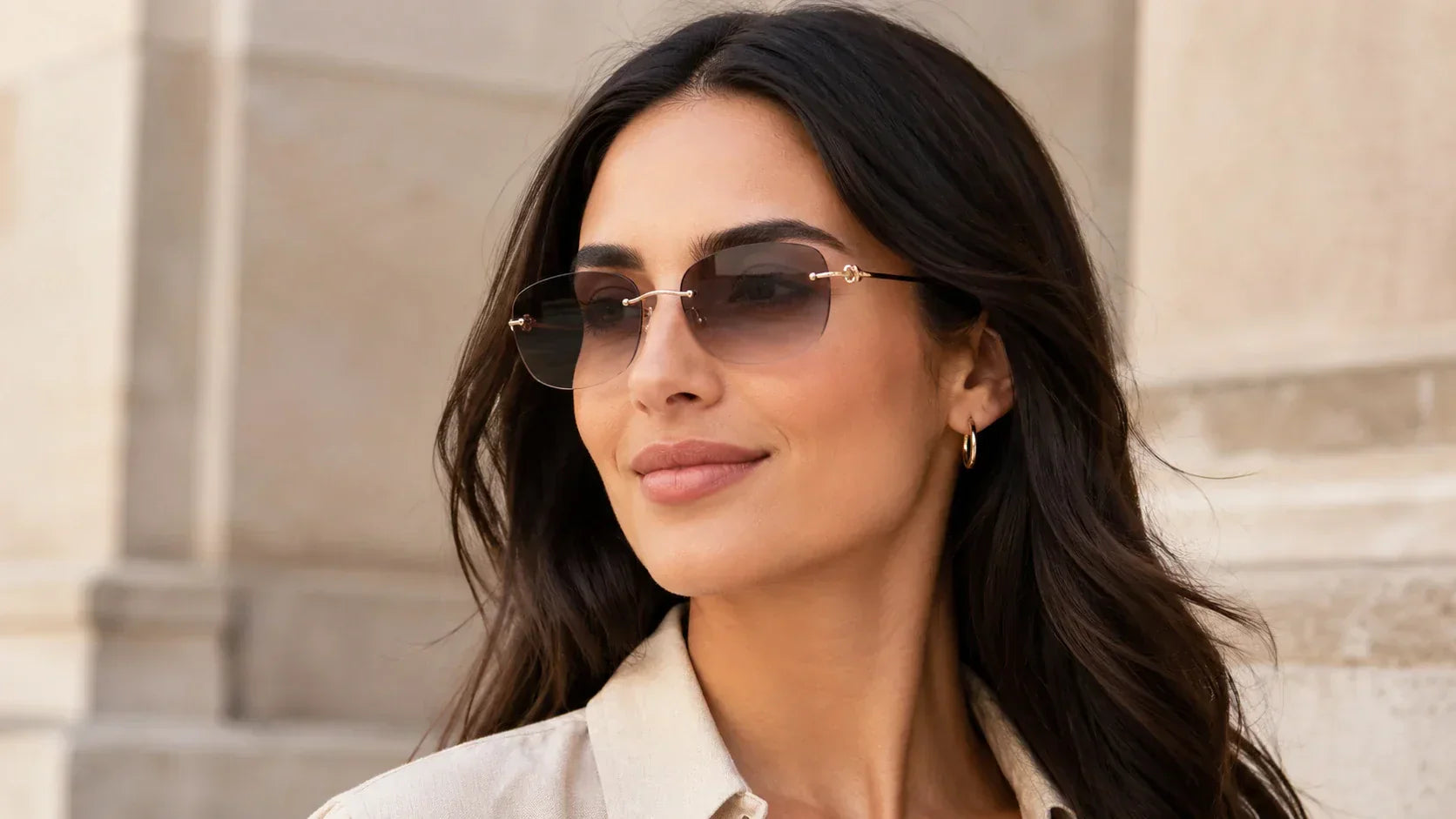 Woman with oval face shape wearing lightweight rimless sunglasses