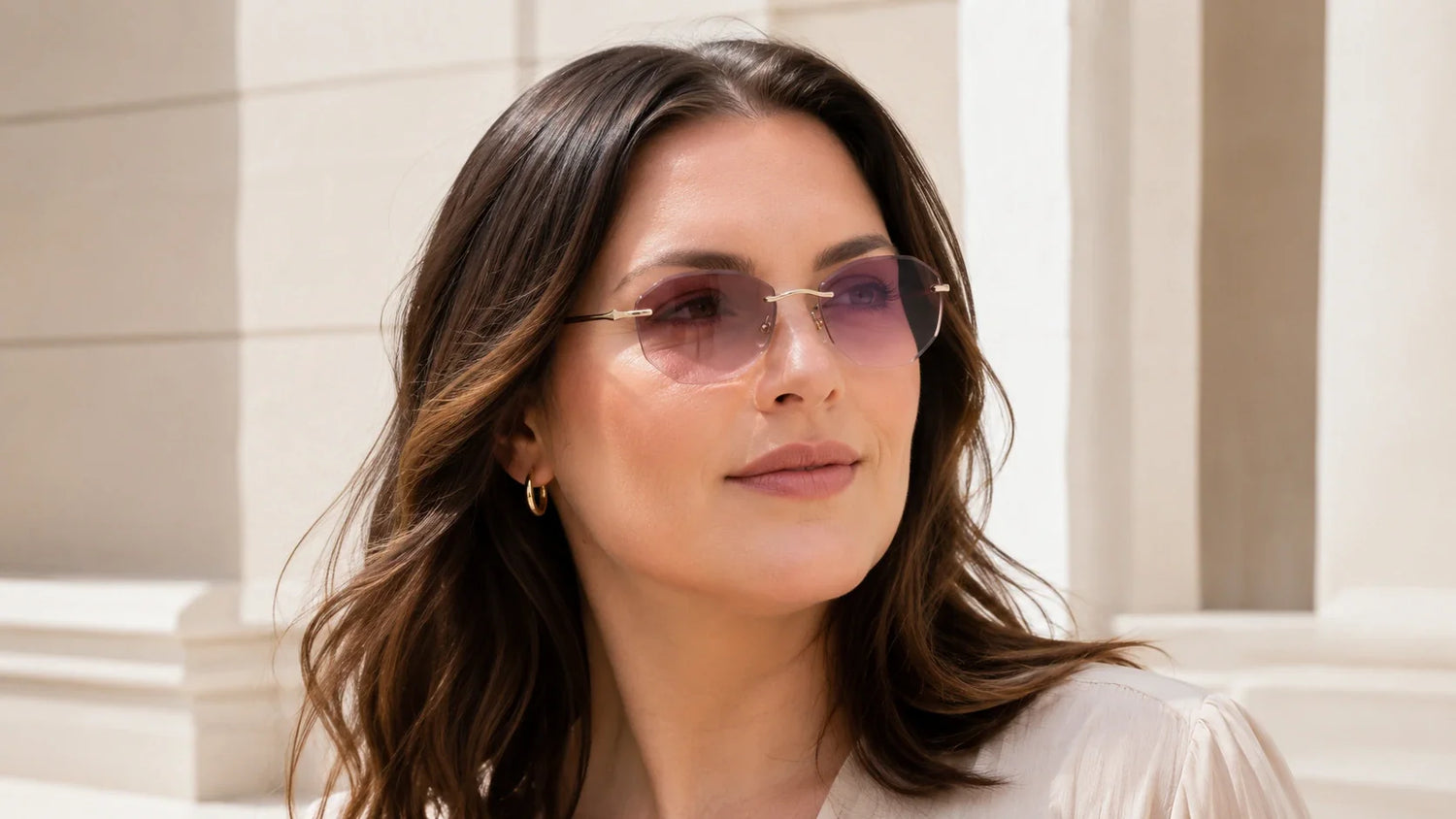 Woman with wide face wearing lightweight rimless sunglasses for an anti-pinch fit