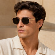 Male model wearing BAPORSSA Aurelia vintage cat-eye sunglasses in a warm outdoor lifestyle setting