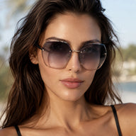 Close-up portrait of a female model wearing BAPORSSA Contour rimless sunglasses with oversized gradient lenses outdoors