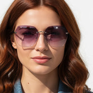 Woman wearing a pair of sunglasses with a blurred background