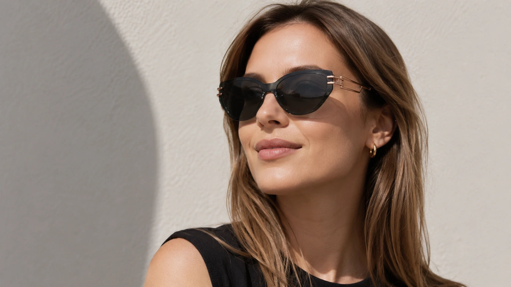 Side-profile of a woman wearing BAPORSSA Edge cat-eye sunglasses,
     showcasing the unique rose gold temple design and smoke grey lenses.