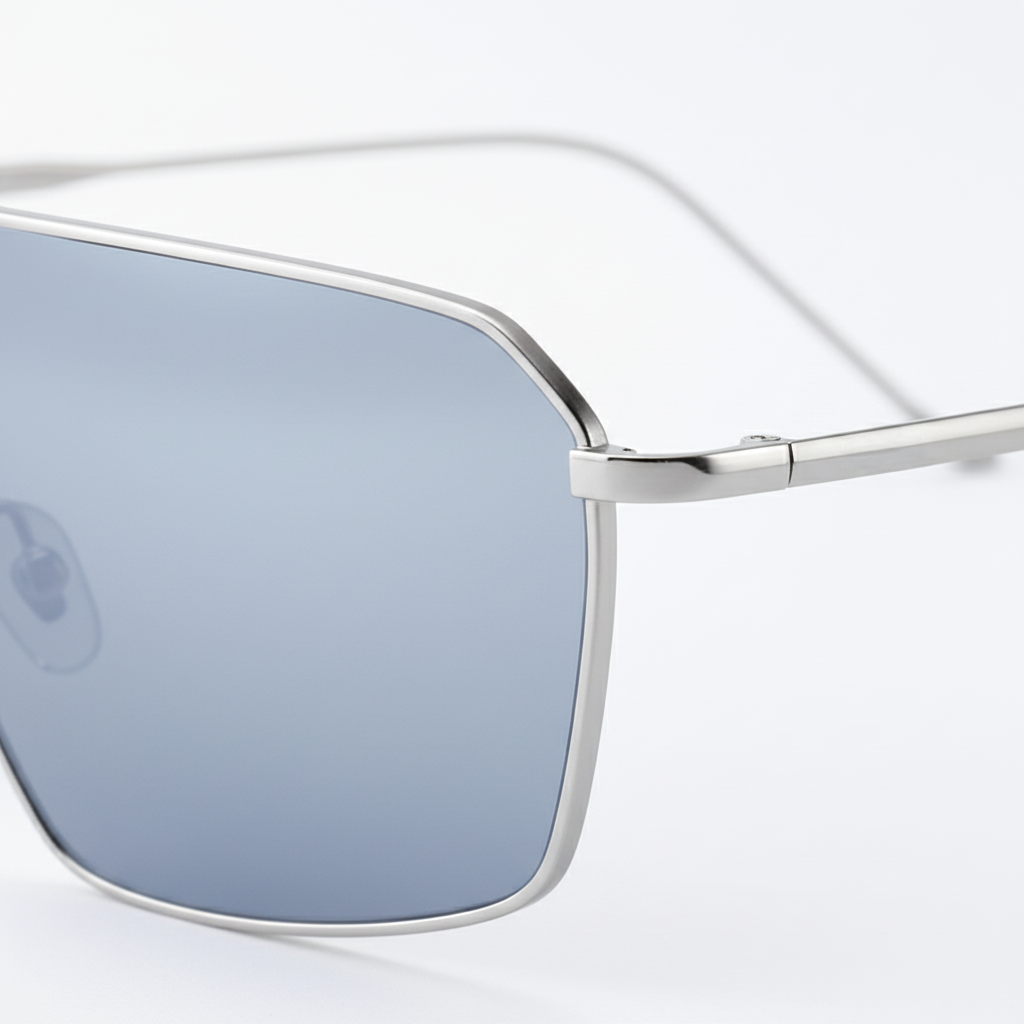 Close-up of BAPORSSA sunglasses hinge detail, silver frame blue lens with engraved logo