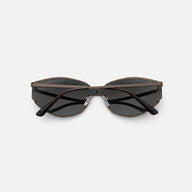 Metallic gunmetal black half-rim cat-eye sunglasses side view floating product photography