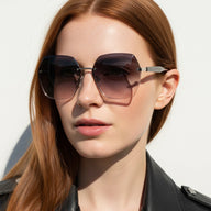 Woman wearing large sunglasses with a neutral background