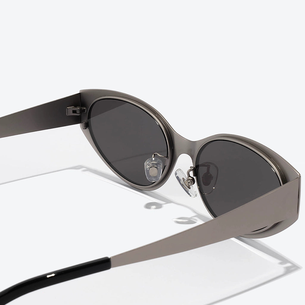 Sunglasses with a metallic frame and dark lenses on a white background