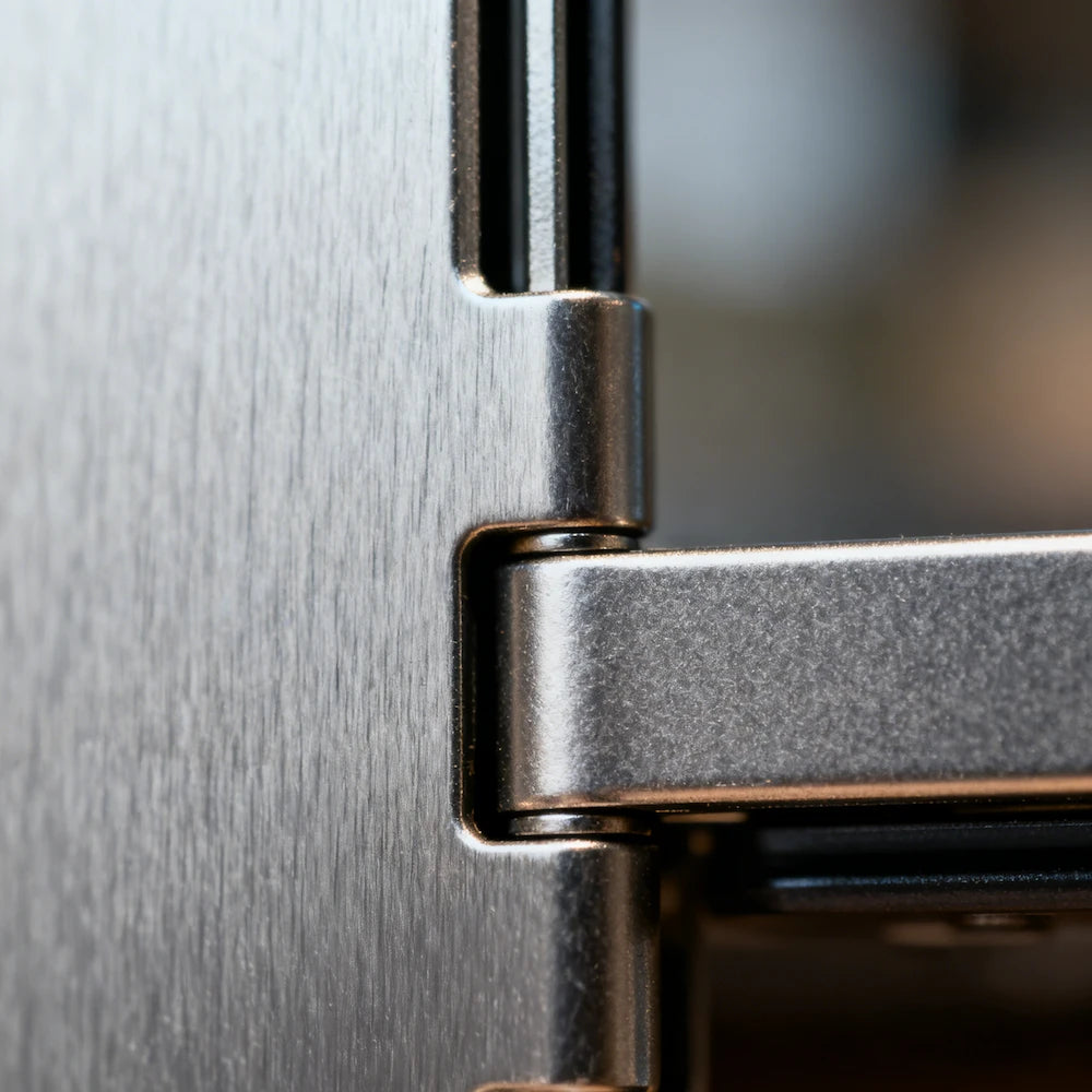 A close-up of a polished metal hinge, showcasing intricate engineering and premium material quality, ideal for highlighting durability in industrial or luxury product design.