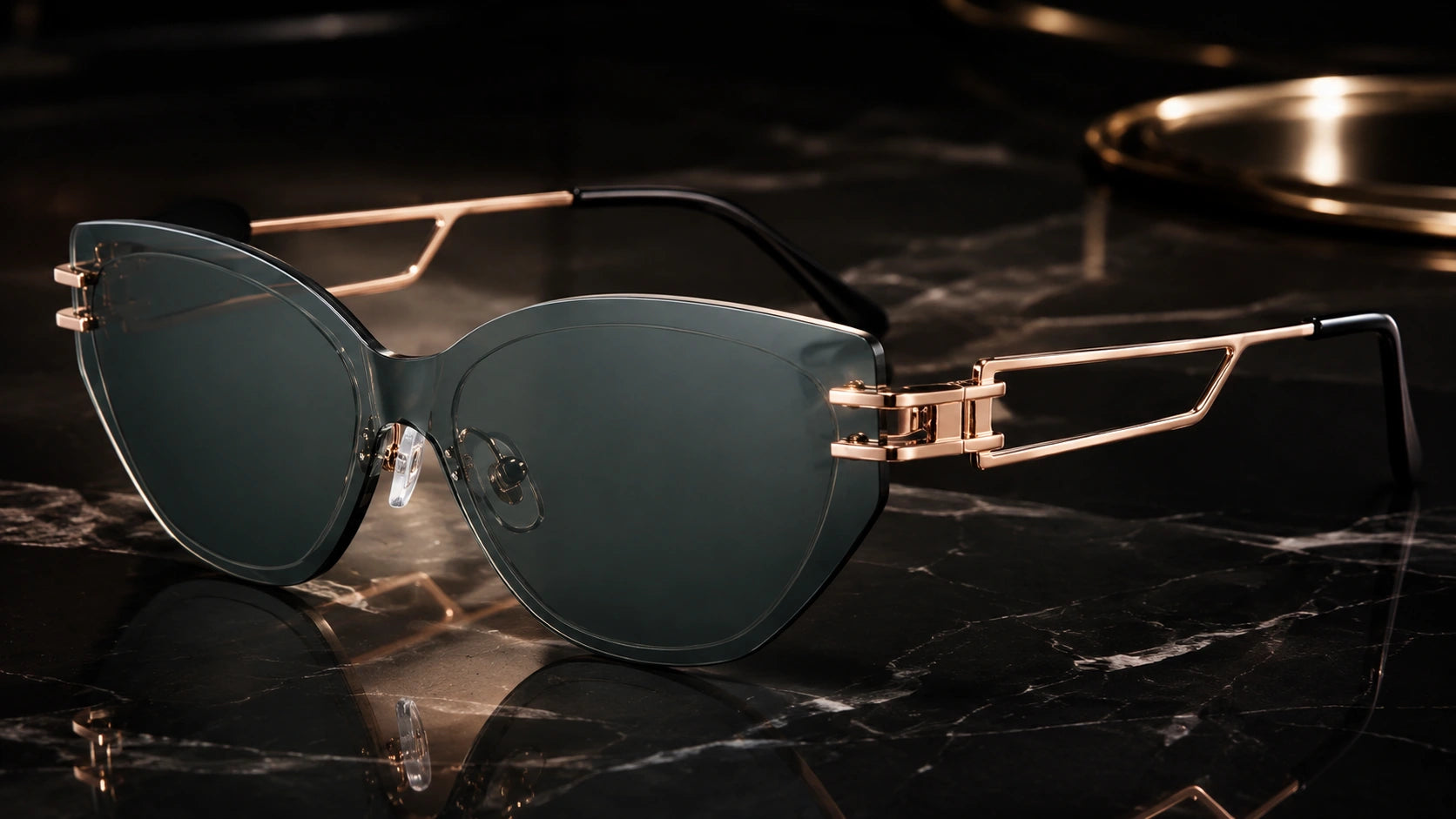 Luxury cat-eye rimless sunglasses with dark green lenses and rose-gold metal temple details shown on black marble, styled like a high-end jewelry and watch campaign.