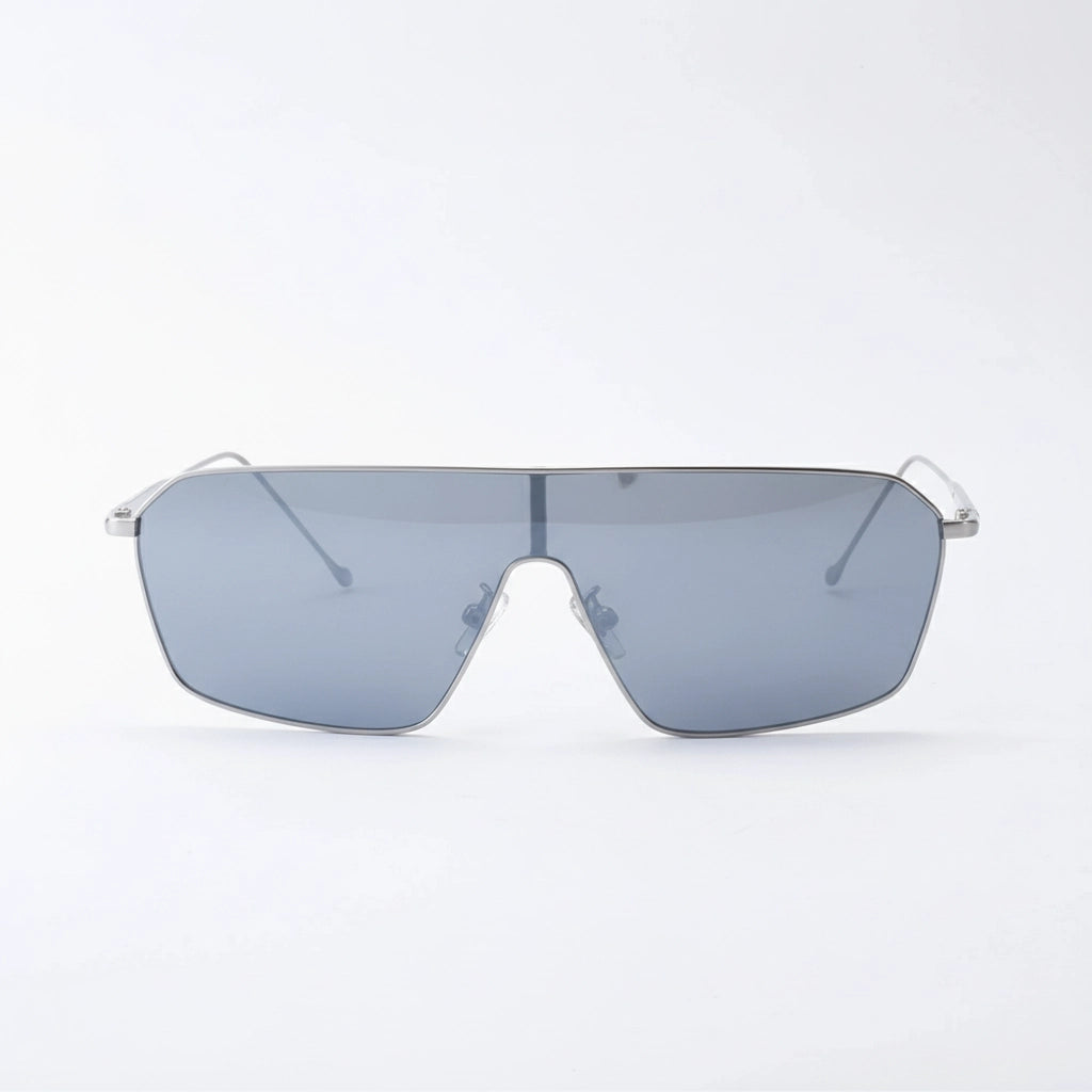 Minimalist oversized flat-top sunglasses with thin silver metal frames and light gray tinted lenses, displayed against a clean white background, showcasing modern, sleek design.