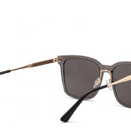 Sunglasses with gold frame and black arms on a white background