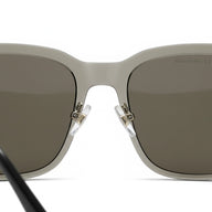Silver sunglasses with dark lenses on a white background