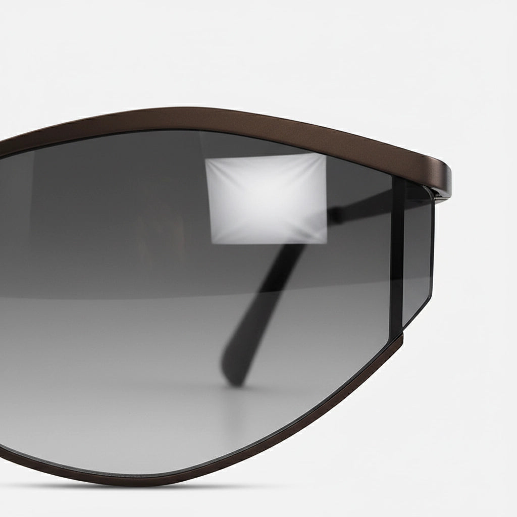Side angle of fashionable cat-eye sunglasses showcasing a slim brown metal frame and gradient gray lenses.