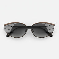 Side angle of fashionable cat-eye sunglasses showcasing a slim brown metal frame and gradient gray lenses.