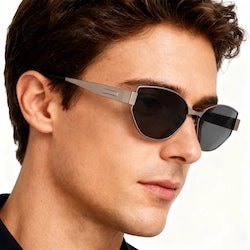 man wears cat-eye metallic sunglasses against a minimalist backdrop, showcasing the style’s versatility and sharp, contemporary design for everyday wear.