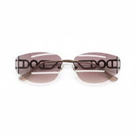 Close side view of model wearing Y2K rimless Pink red sunglasses with visible DO letter temple