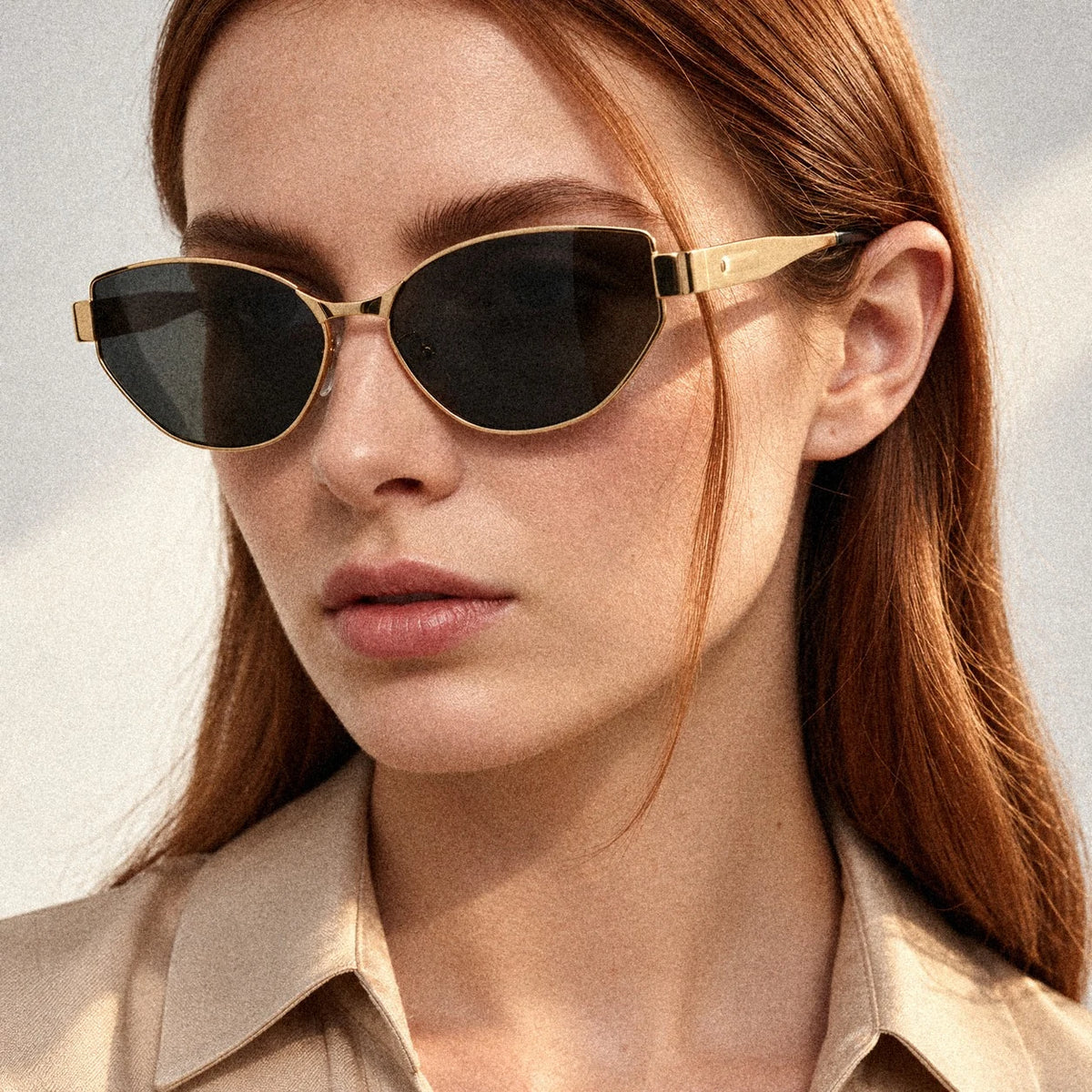BAPORSSA Onyx titanium cat-eye sunglasses in Gold Black, worn by a model, side view