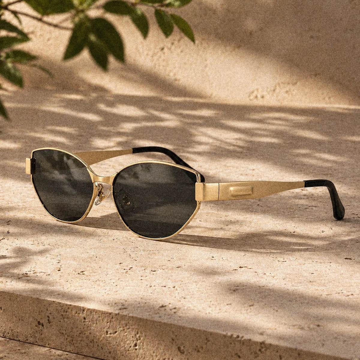 BAPORSSA Onyx sunglasses in Gold Black on sunlit stone
