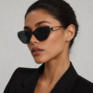 A three-quarter view portrait of a woman wearing Baporssa Edge rimless cat-eye fashion sunglasses, emphasizing the unique lens cut and temple connection.