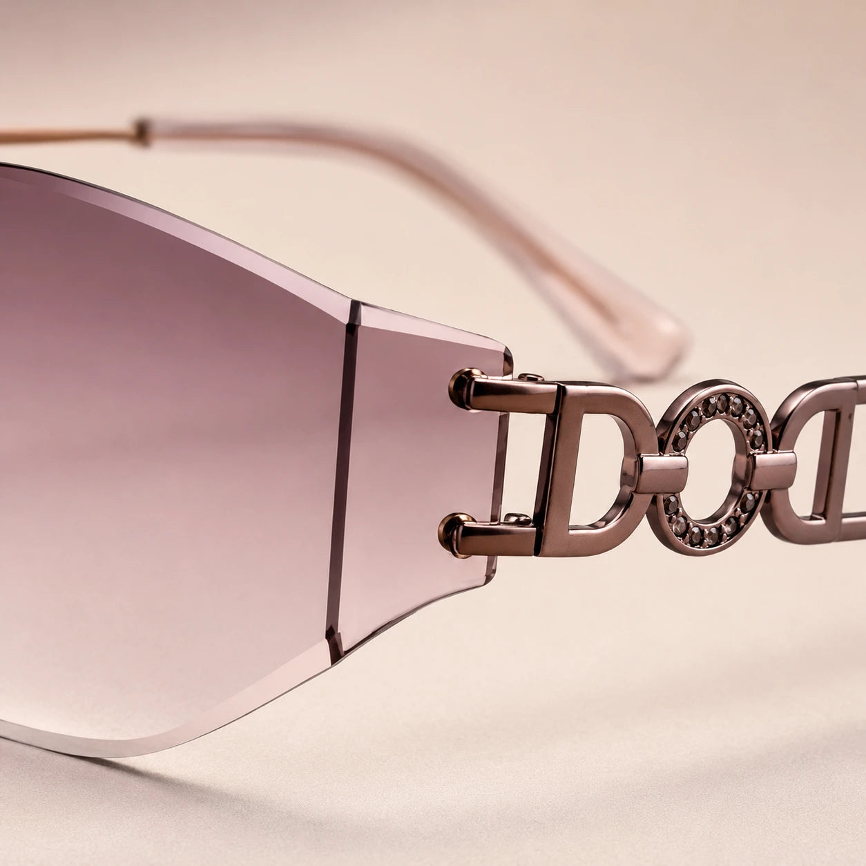 A macro detailed shot of Baporssa Muse sunglasses, focusing on the sophisticated interlocking letter design and rhinestone circular embellishments on the metal temple arm.