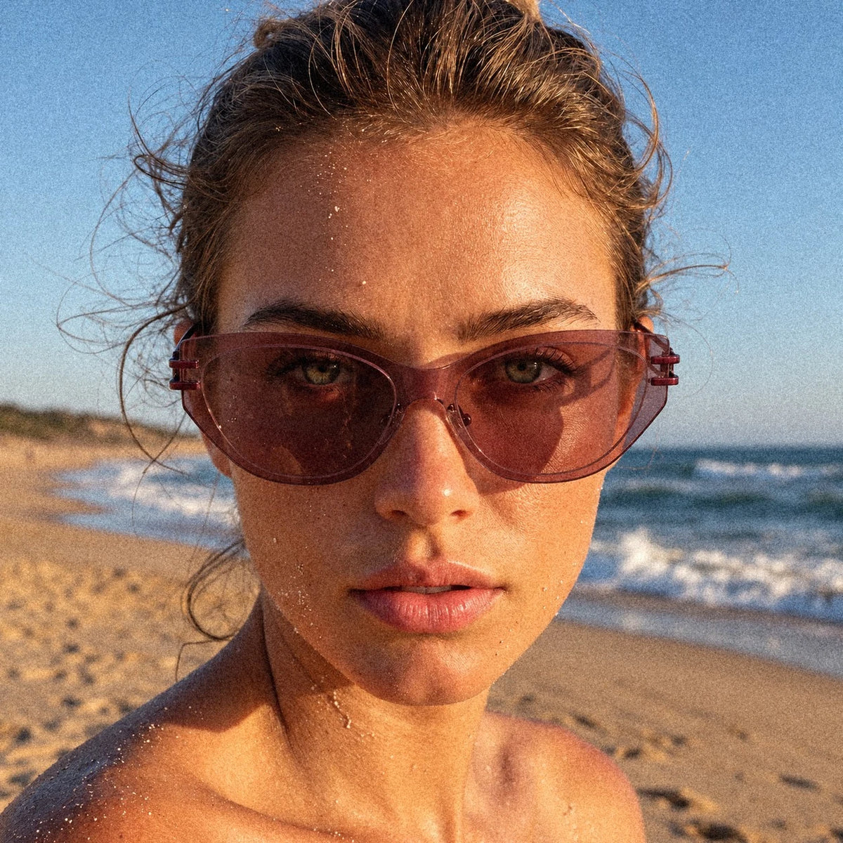 BAPORSSA Edge sunglasses in Claret, worn by a model on the beach