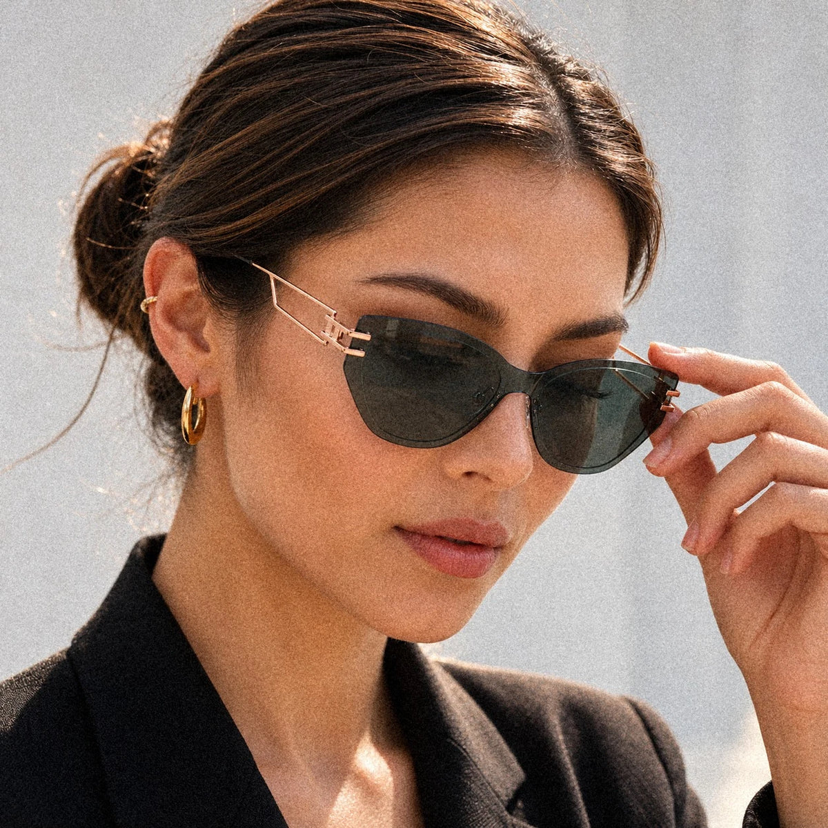 BAPORSSA Edge sharp cat-eye sunglasses in Grey-Green, worn by a model, close up