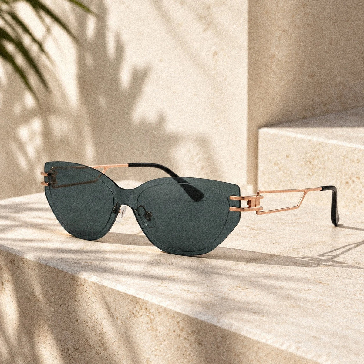 BAPORSSA Edge sunglasses in Grey-Green on a sunlit stone step