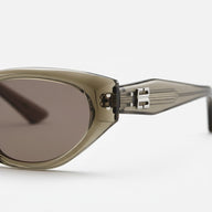 Sunglasses with a metallic frame and dark lenses on a white background