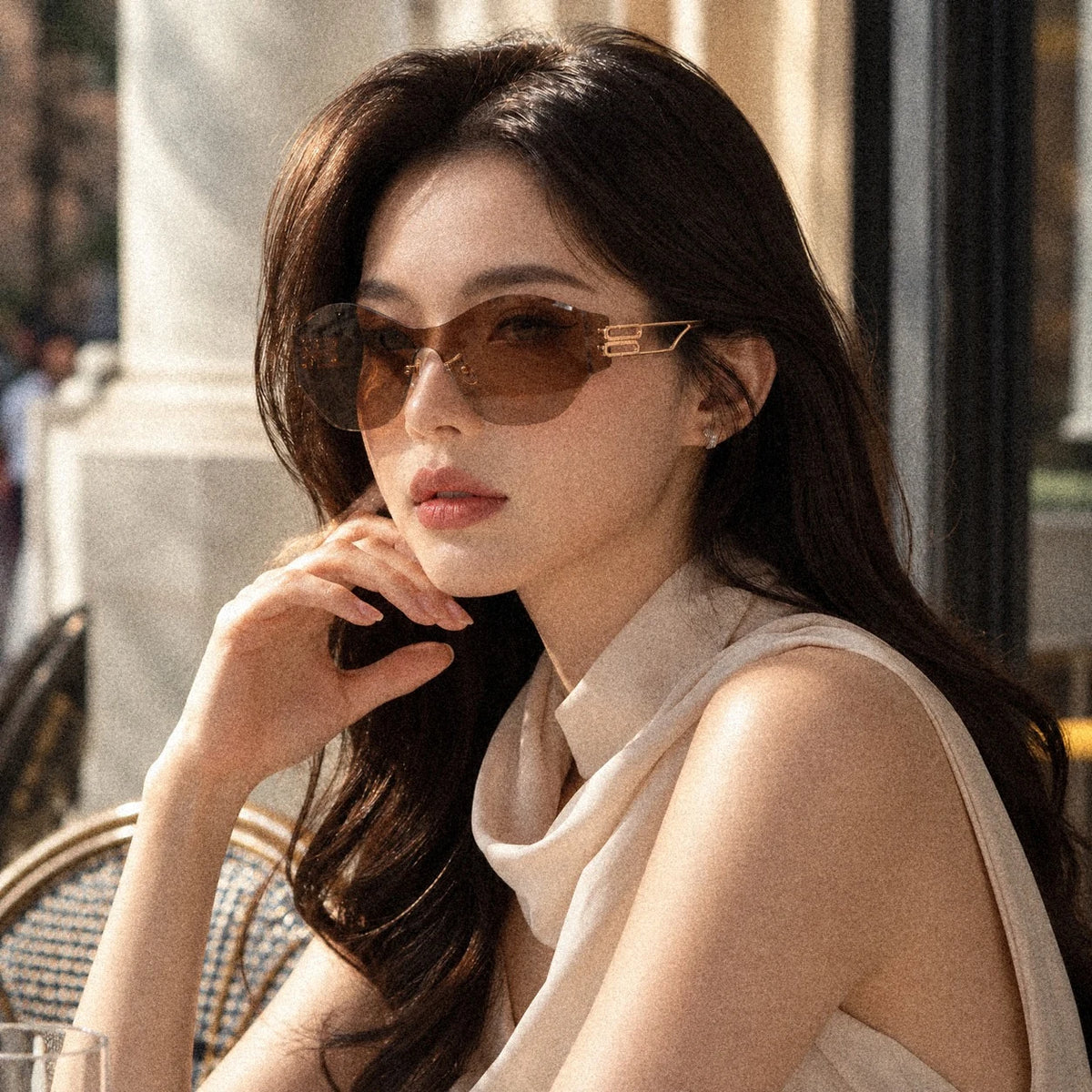 BAPORSSA Vanguard sunglasses in Bronze, worn by a model at an outdoor cafe