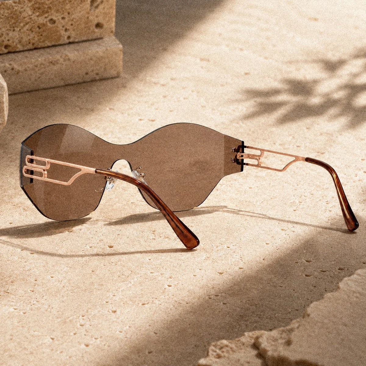 BAPORSSA Vanguard sunglasses in Bronze on travertine