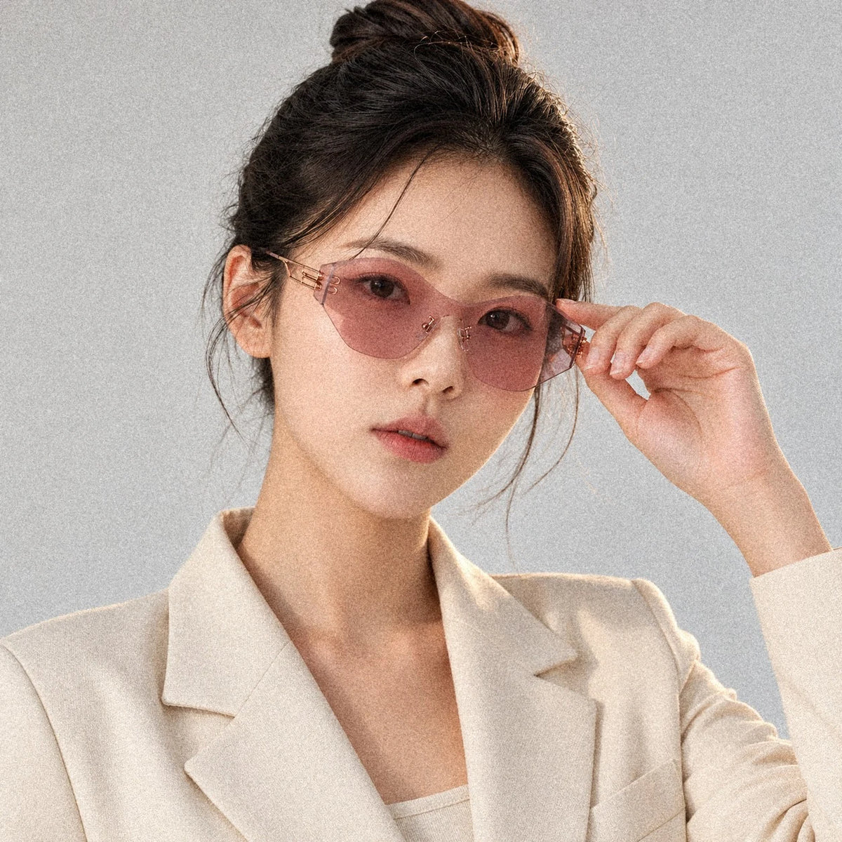 BAPORSSA Vanguard sunglasses in Pink, worn by a model, adjusting the frame